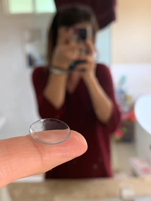 me holding a contact lens